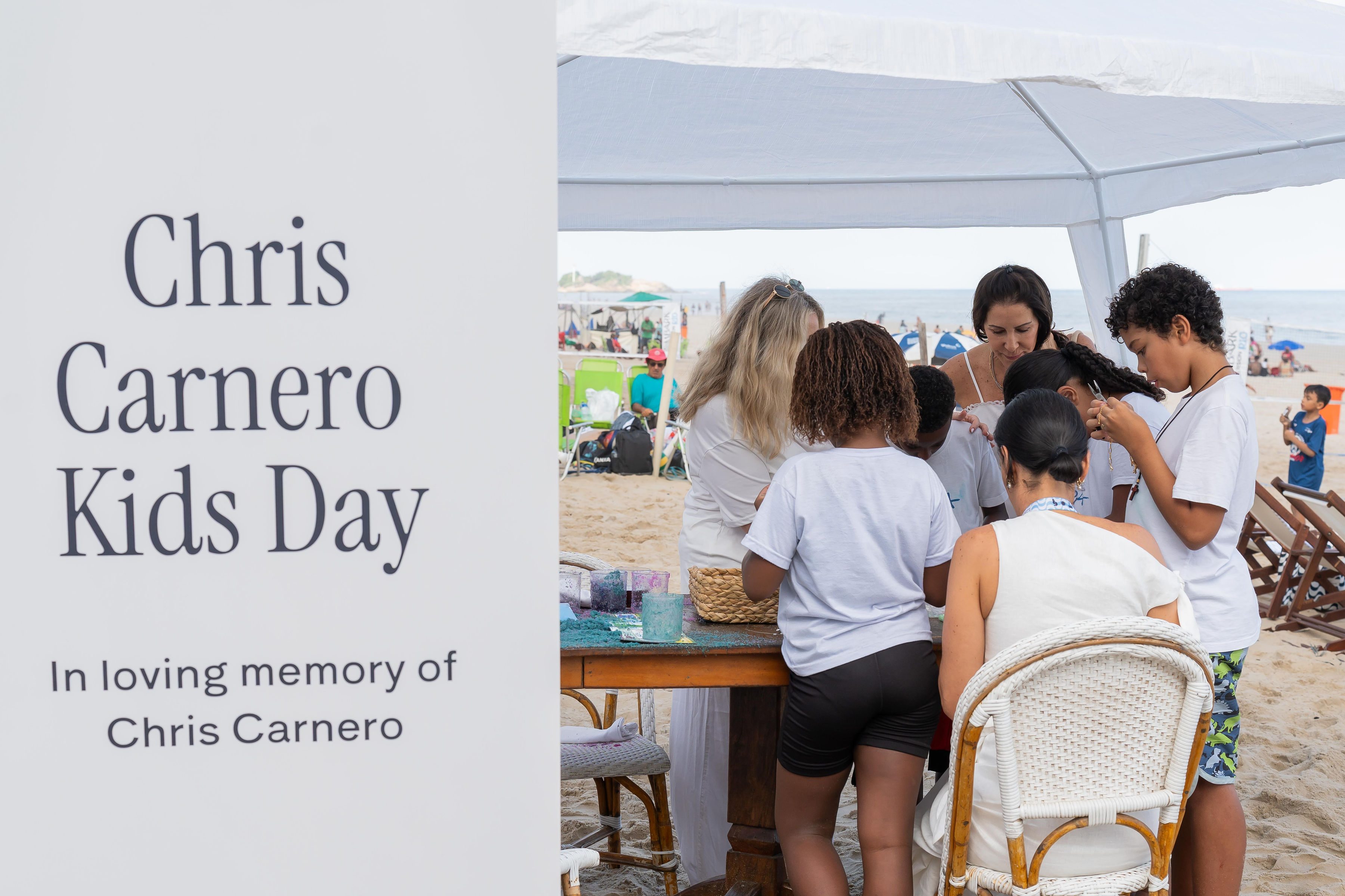 Chris Carnero Kids Day — In loving memory of Chris Carnero, beside children taking part in activities on the beach